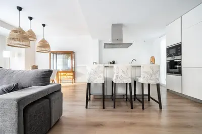 a kitchen and living room with a table and chairs at Casa señorial en el corazón del Puerto by Hometels in Puerto de Sagunto