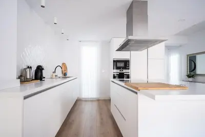 a white kitchen with white counters and white appliances at Casa señorial en el corazón del Puerto by Hometels in Puerto de Sagunto