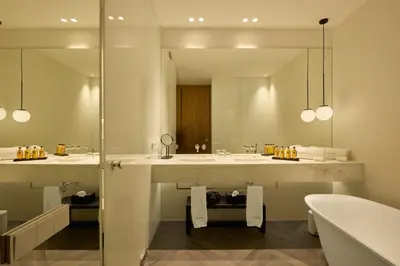 a bathroom with two sinks and a mirror and a tub at La Galiana Golf Resort - Adults Only in Barraca de Aguas Vivas