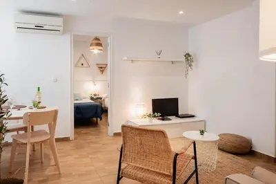 a living room with a couch and a table with a tv at Apartamentos FV Flats Valencia - Mestalla 9 in Valencia