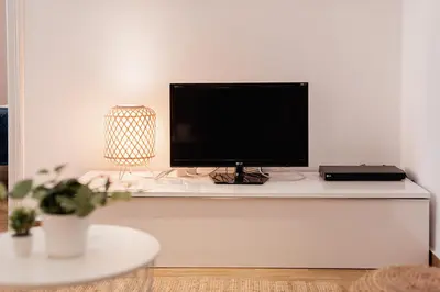 a flat screen tv sitting on a white shelf at Apartamentos FV Flats Valencia - Mestalla 9 in Valencia