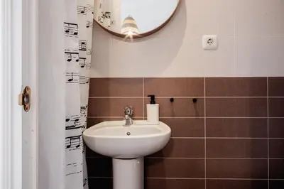 a bathroom with a sink and a mirror at Apartamentos FV Flats Valencia - Mestalla 9 in Valencia