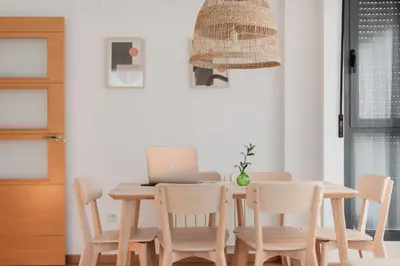 a dining room with a table with a laptop on it at Apartamentos FV Flats Valencia - San Felipe Neri in Valencia