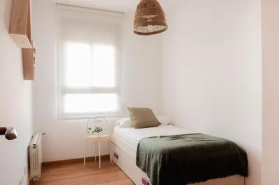 a small bedroom with a bed and a window at Apartamentos FV Flats Valencia - San Felipe Neri in Valencia