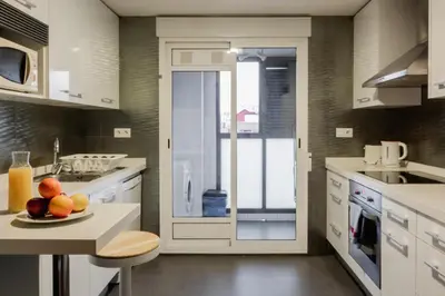a kitchen with a plate of fruit on a table at Apartamentos FV Flats Valencia - San Felipe Neri in Valencia