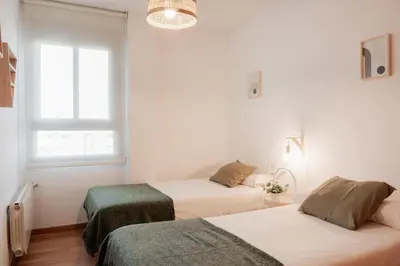 a bedroom with two beds and a window at Apartamentos FV Flats Valencia - San Felipe Neri in Valencia