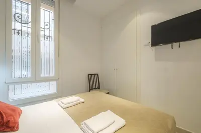 a bedroom with a bed with two towels on it at Room close to City Centre in Valencia