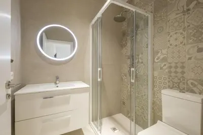 a bathroom with a shower and a toilet and a mirror at Room close to City Centre in Valencia