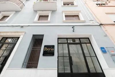 a white building with a sign on it at Room close to City Centre in Valencia