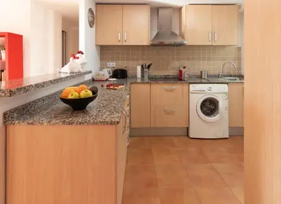 a kitchen with a bowl of fruit on a counter at LUMINOSO. COMODO. ACOGEDOR. WIFI. Junto a AVE in Valencia