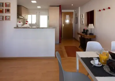 a kitchen and living room with a table and chairs at LUMINOSO. COMODO. ACOGEDOR. WIFI. Junto a AVE in Valencia