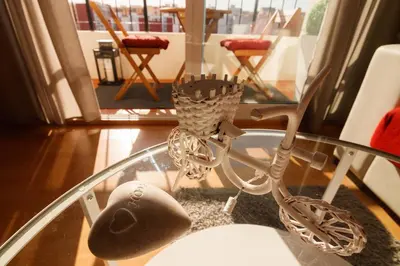 a glass coffee table with a bike on a rug at LUMINOSO. COMODO. ACOGEDOR. WIFI. Junto a AVE in Valencia
