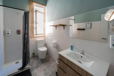 a bathroom with a sink and a toilet and a shower at The Venue Hostel Boutique in Valencia