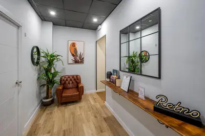 a waiting room with a chair and a mirror at The Venue Hostel Boutique in Valencia