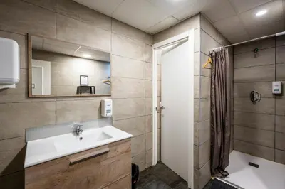 a bathroom with a sink and a shower at The Venue Hostel Boutique in Valencia