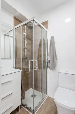 a bathroom with a shower and a toilet at Ático con espectacular terraza y vistas al mar in El Perelló