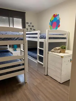 a room with two bunk beds and a room with at 3Apto con piscina en la playa cerca de VLC con AC in Puzol