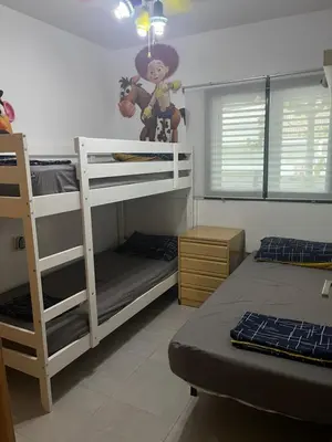 a bedroom with two bunk beds and a monkey on the wall at PLAYA ALMARDA,PISCINA,2 TERRAZAS,WIFI,PARKING,BBQ,TRANQUILo in Sagunto