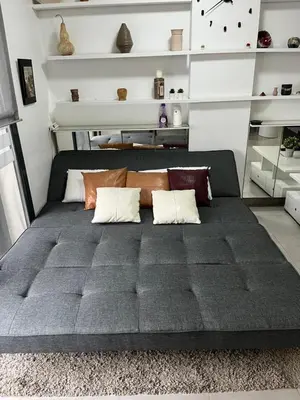 a large bed in a room with white shelves at PLAYA ALMARDA,PISCINA,2 TERRAZAS,WIFI,PARKING,BBQ,TRANQUILo in Sagunto