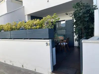 a house with plants on the side of it at PLAYA ALMARDA,PISCINA,2 TERRAZAS,WIFI,PARKING,BBQ,TRANQUILo in Sagunto