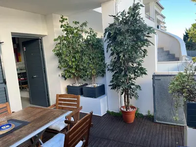 a patio with a table and chairs and potted trees at PLAYA ALMARDA,PISCINA,2 TERRAZAS,WIFI,PARKING,BBQ,TRANQUILo in Sagunto