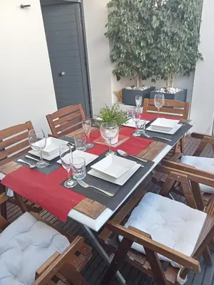 a table with a red table cloth and glasses on it at PLAYA ALMARDA,PISCINA,2 TERRAZAS,WIFI,PARKING,BBQ,TRANQUILo in Sagunto