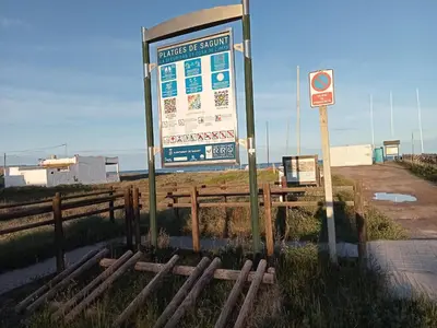 a sign next to a fence next to a road at PLAYA ALMARDA,PISCINA,2 TERRAZAS,WIFI,PARKING,BBQ,TRANQUILo in Sagunto