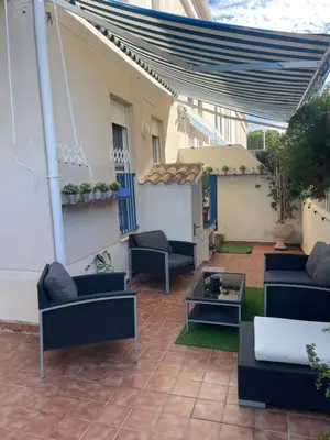 a patio with couches and a table at PLAYA ALMARDA CORINTO, PISCINA, WIFI,2 TERRAZAS, BARBACOA,TRANQUILo in Sagunto