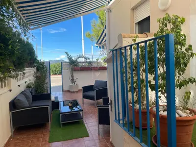 a balcony of a house with chairs and a table at PLAYA ALMARDA CORINTO, PISCINA, WIFI,2 TERRAZAS, BARBACOA,TRANQUILo in Sagunto