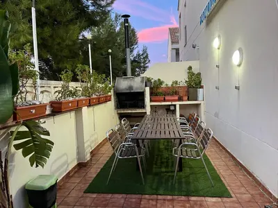 a patio with a table and chairs on a balcony at PLAYA ALMARDA CORINTO, PISCINA, WIFI,2 TERRAZAS, BARBACOA,TRANQUILo in Sagunto