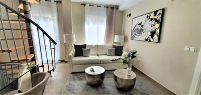 a living room with a couch and a table at Balmes Street in Valencia