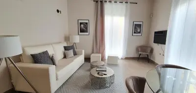a white living room with a couch and a table at Balmes Street in Valencia