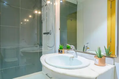 a bathroom with a sink and a shower at Balmes Street in Valencia