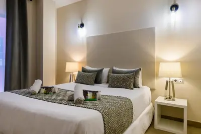 a hotel room with two beds and two lamps at Balmes Street in Valencia