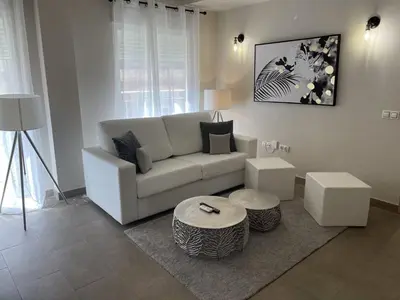 a living room with a white couch and a table at Balmes Street in Valencia
