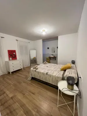 a bedroom with a bed and a table and a chair at Torbellino de Colores in Benaguacil