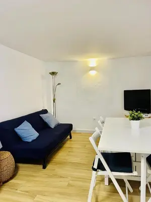 a living room with a couch and a table at Torbellino de Colores in Benaguacil