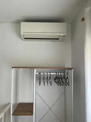 a kitchen with a vent and hangers in a room at Torbellino de Colores in Benaguacil