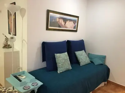 a blue couch with two pillows in a room at Apartamento Valencia in Catarroja