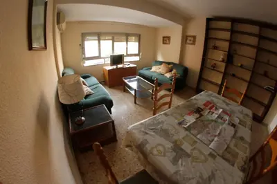 a small living room with a table and a couch at bigger flat for holiday near beach ideal for familie with climatisacion in Valencia
