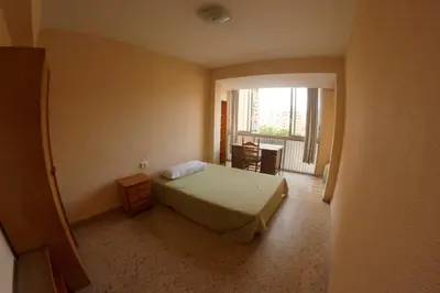 a small bedroom with a bed and a window at bigger flat for holiday near beach ideal for familie with climatisacion in Valencia