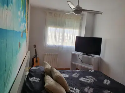 a room with a bed and a tv and a guitar at Apartamento Almenara Nova Almenareta in Almenara