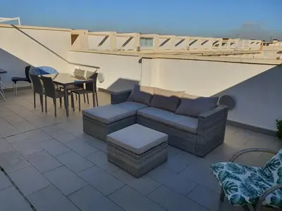 a patio with a couch and a table and chairs at Apartamento Almenara Nova Almenareta in Almenara