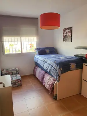 a bedroom with a bed and a red lamp at Apartamento Almenara Nova Almenareta in Almenara