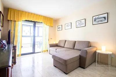 a living room with a couch and a tv at 13 ESPACIO SOBRE MAR in Cullera