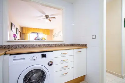 a white laundry room with a washer and dryer at 13 ESPACIO SOBRE MAR in Cullera
