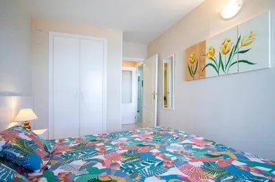a bedroom with a bed with a colorful blanket at 13 ESPACIO SOBRE MAR in Cullera