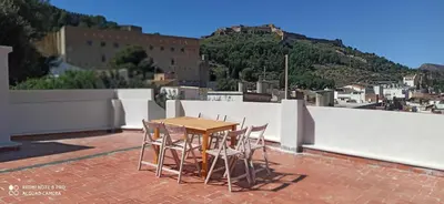 a table and chairs sitting on a roof at La Casa Baja in Sagunto