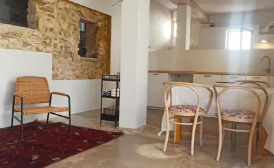 two chairs and a table in a kitchen at La Casa Baja in Sagunto