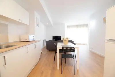 a kitchen and living room with a table and chairs at Global Vacacional, Increíble apartamento con vistas al mar, Canet d'en Berenguer in Canet de Berenguer